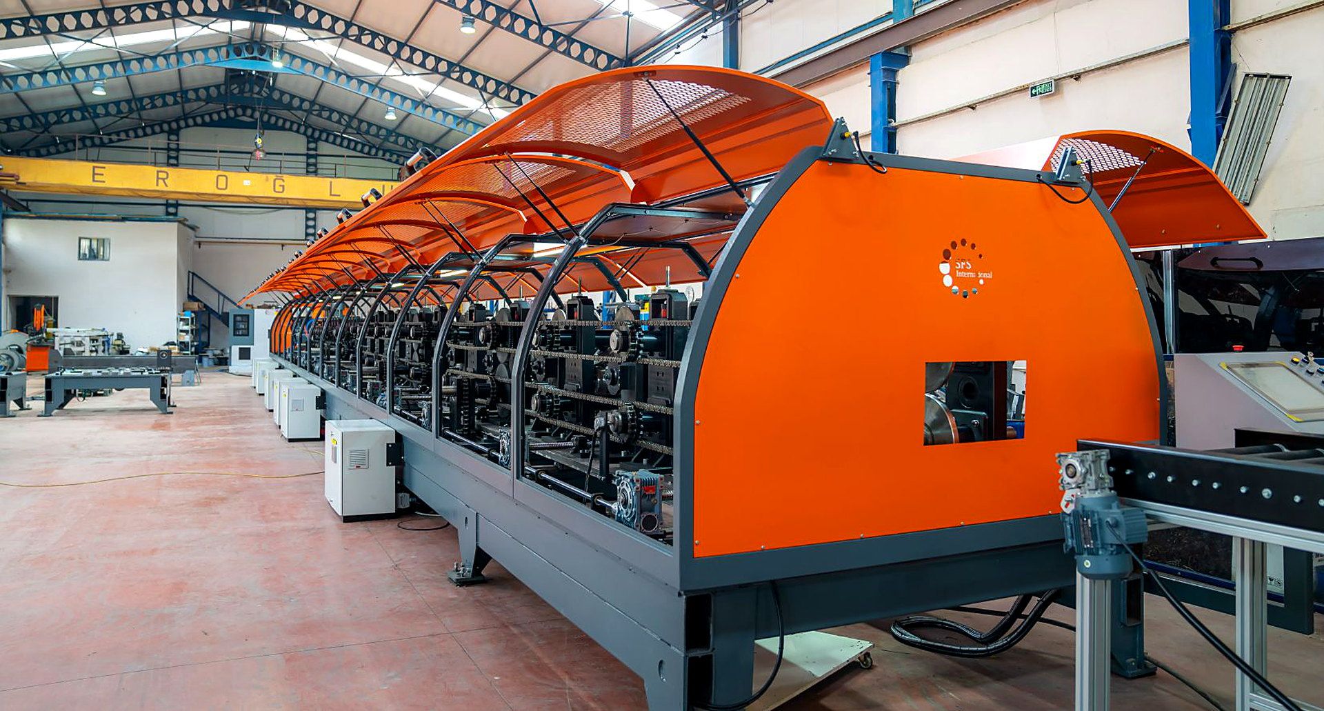 Auto-Form purlin roll-forming line with orange guarding in a factory hall