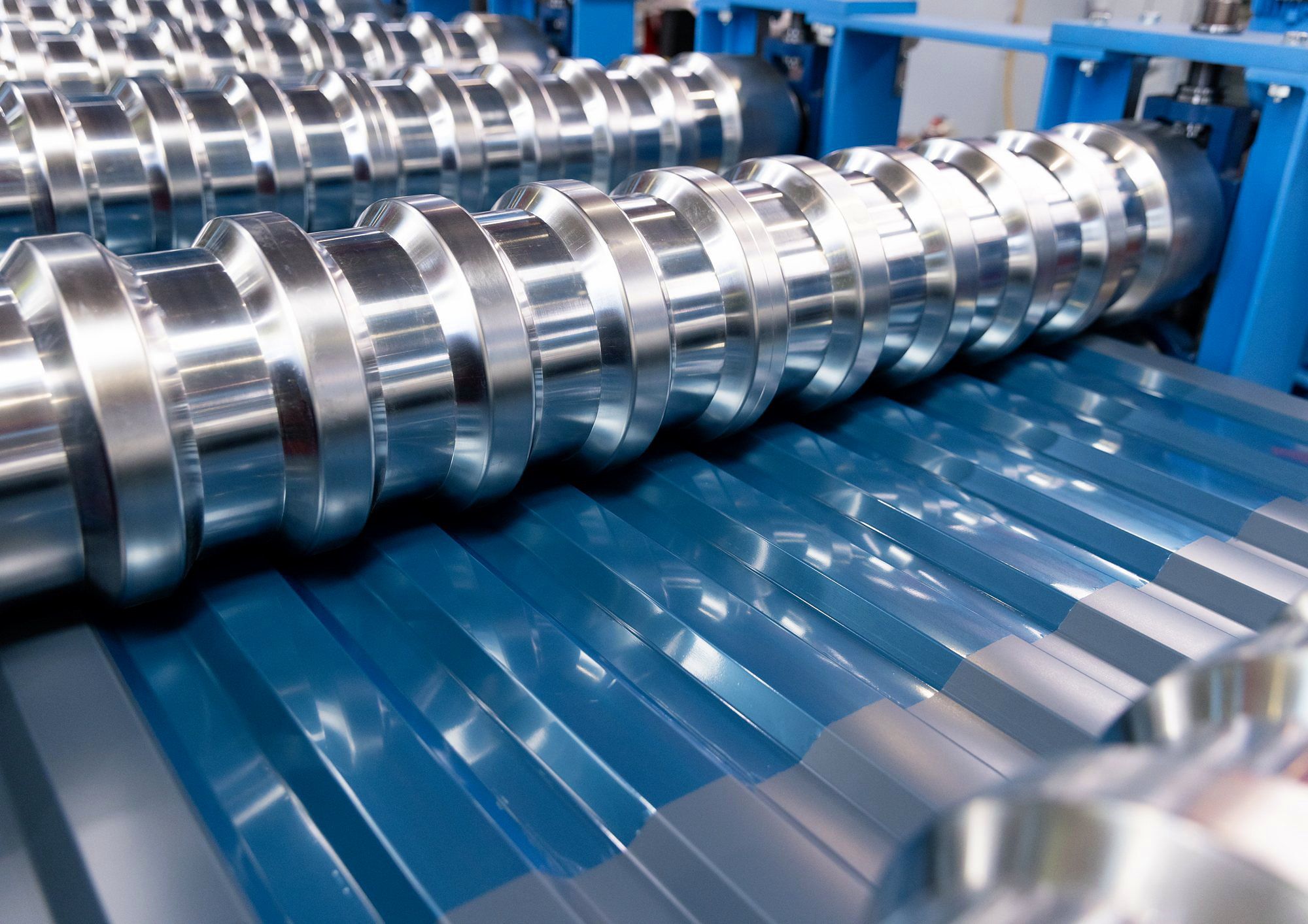 Roll-forming tooling shaping a blue steel cladding profile