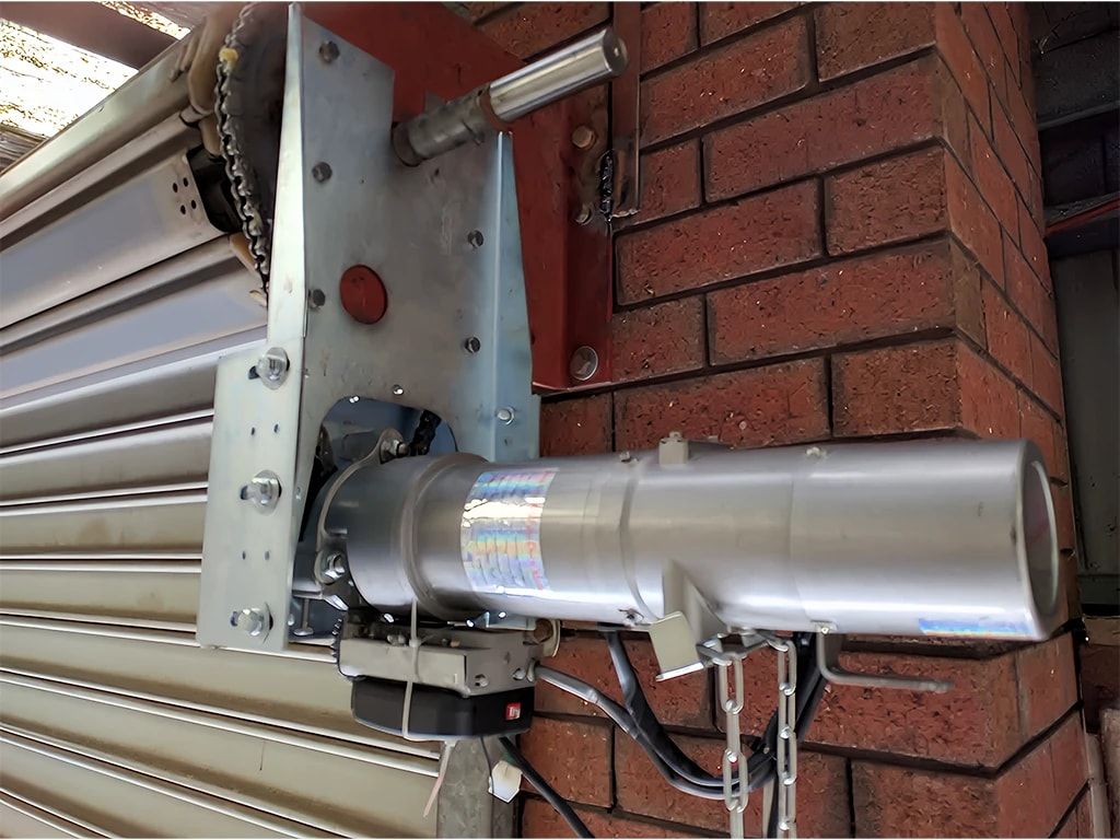 TOM Door roller door system mounted on a brick opening